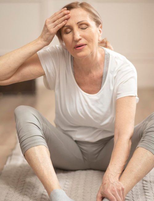 cheerful-middle-aged-woman-relaxing-after-making-yoga-exercises_549566-92