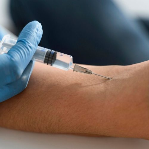 doctor-injecting-vaccine-woman-s-arm_23-2148755663